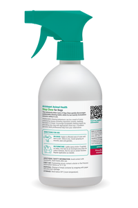 White spray bottle with green nozzle on a white background