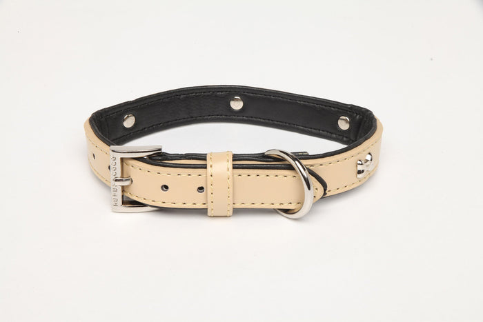 Rufus and Coco classic stud dog collar gives your dog a chic look at an affordable price. Available in leather look in 4 colours - beige, black, red and pink. The adjustable dog collar comes with silver bone shaped studs, sturdy D ring to attach your lead, and silver signature logo buckle.